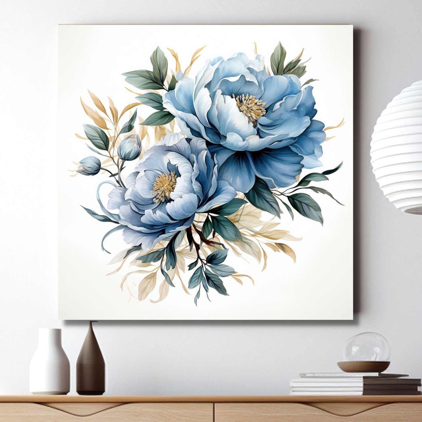 Grafisk motiv av blå blomster med grønt bladverk. Motivet fås som plakat og på lerrett. Miljøbilde av motiv på lerret på en vegg over en komode.