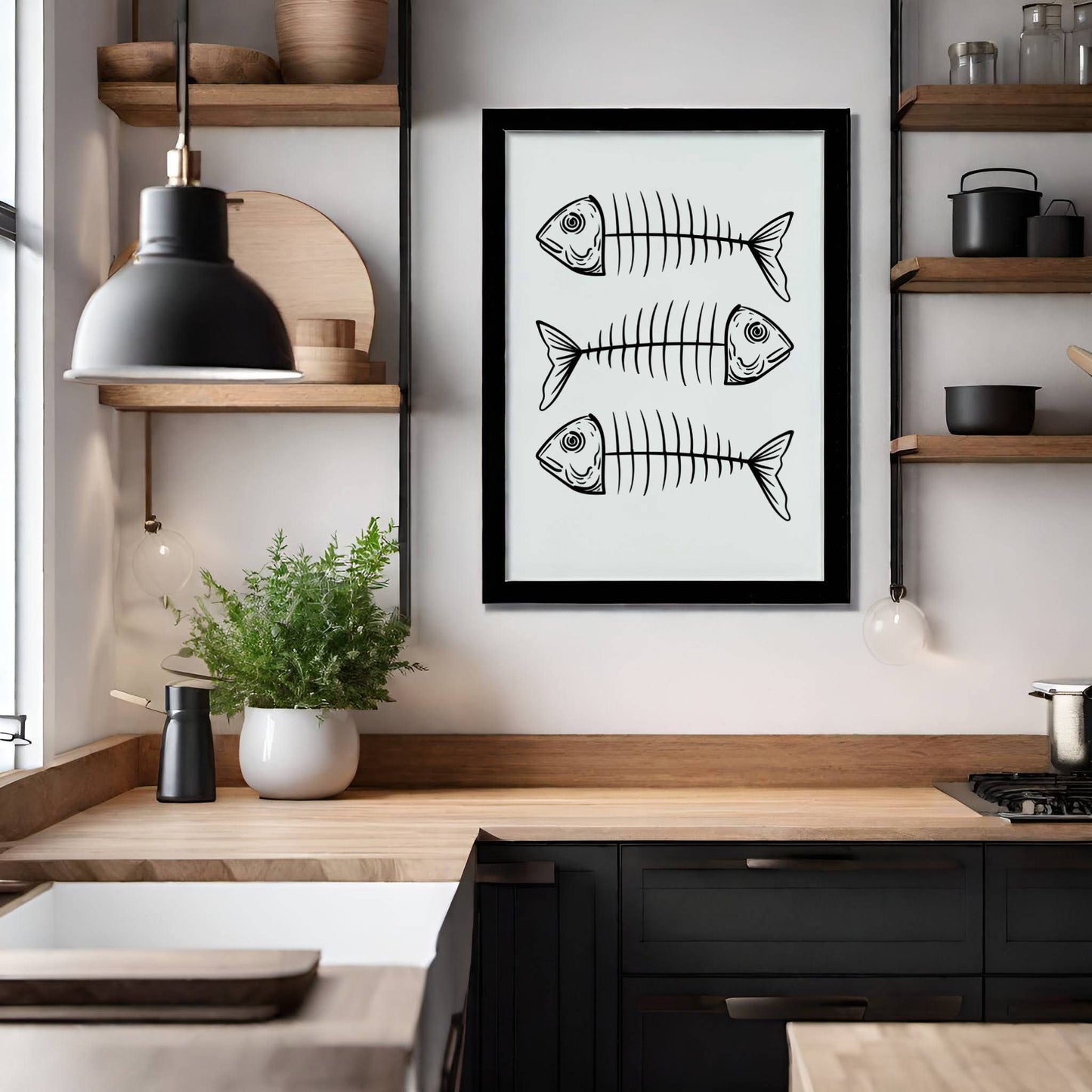 FISKEBEIN – grafisk plakat er en humoristisk og moderne illustrasjon med tre stiliserte fiskeskjelett, gjengitt i sort strek på lys bakgrunn. Illustrasjon viser plakat i sort ramme på et kjøkken