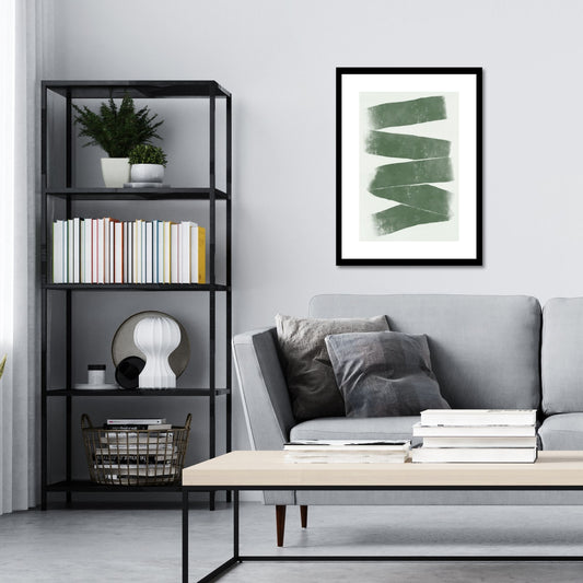 Green Abstract plakat. Med sine beroligende grønne toner og sofistikerte design, tilfører denne plakaten en følelse av ro og harmoni til ethvert rom. Illustrasjonen viser plakat i sort ramme på en vegg over en sofa.
