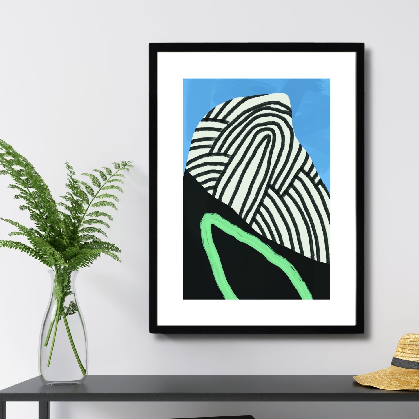 Modern Abstract Art No2 er en unik plakat som kombinerer abstrakte mønstre og dristige farger i svart, hvitt, blått og grønt. Illustrasjonsfoto viser plakaten i svart ramme.