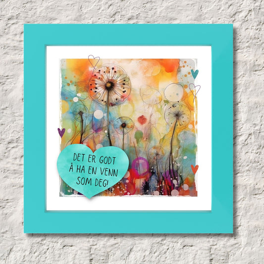 Plakat med turkist hjerte og tekst "Det er godt å ha en venn som deg" - og et motiv med farger i grønn, blått og oransje. Med hvit kant på 1,5 cm. Illustrasjon viser plakat i turkis ramme.