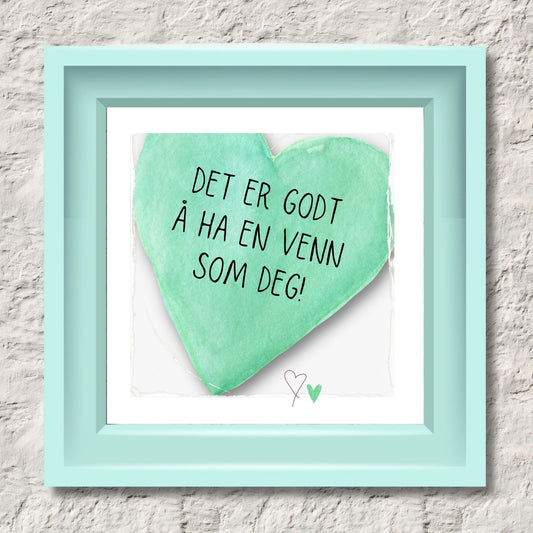 Plakat med lysegrønt hjerte og tekst "Det er godt å ha en venn som deg". Med hvit kant på 1,5 cm. Illustrasjon viser plakat i lysegrønt ramme.
