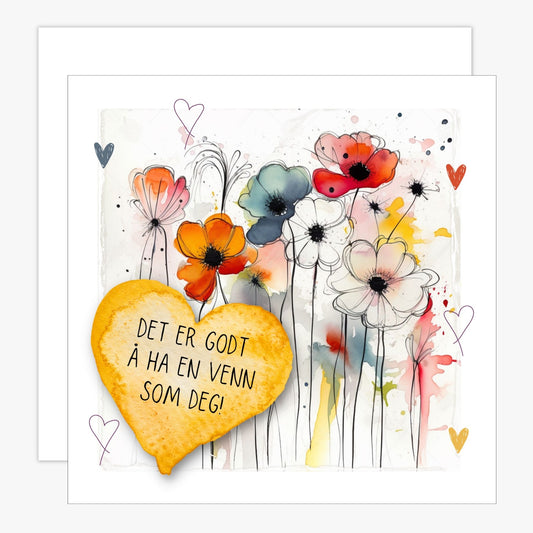 Kort med lys oransje hjerte med tekst "Det er godt å ha en venn som deg" og bakgrunn med fargerik blomstereng. Konvolutt er inkludert.