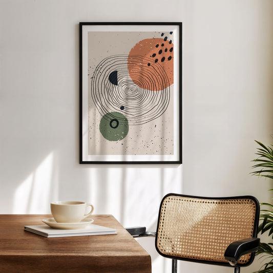 Circular Rhythm grafisk plakat i sort ramme over trebord og rottingstol i lyst interiør