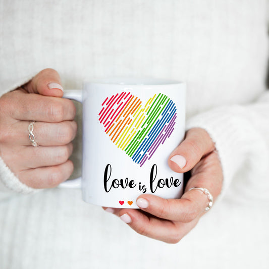 Nærbilde av Love is Love krus med fargerikt regnbuehjerte og dekorative hjerter.