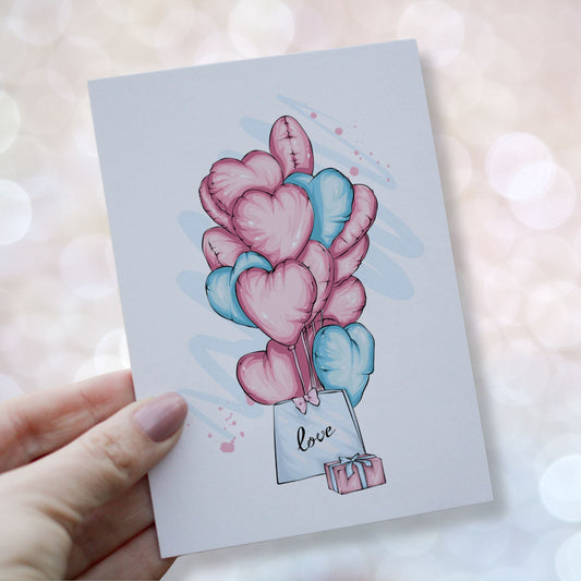 Valentineskort med hjerteballonger i rosa og blå toner, gave og pose med teksten love, lett og romantisk stil. Kortet blir holdt i en hånd.