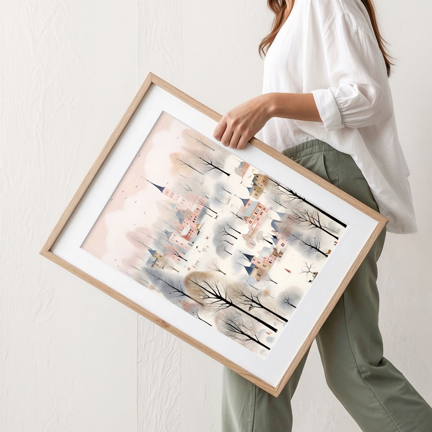 Vinterbyen i Pastellskogen plakat med pastellfargede bygninger, snødekte trær og vinterlig bylandskap. Illustrasjon viser plakat med passepartout i eik ramme.