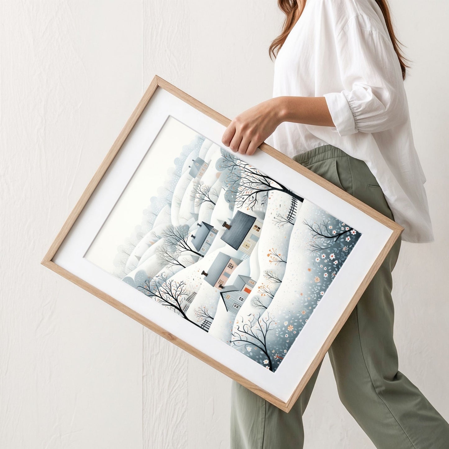 Vinterdalen plakat med snødekte åser, små hus og rolige nordiske vinterfarger. Illustrasjon viser plakat med passepartout i eik ramme.