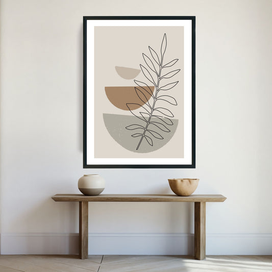Brown Modern Art No2 - abstrakt motiv i brune nyanser som plakat og lerret. Plakaten har en hvit kant som gir dybde og fremhever motivet.  Illustrasjon viser plakat i sort ramme på en vegg.