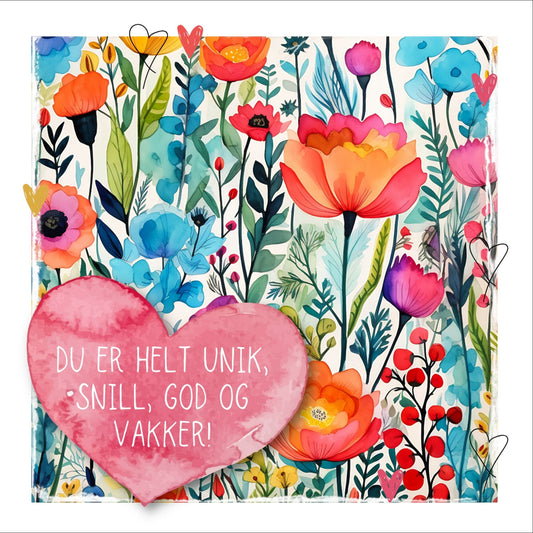 Grafisk plakat med et rosa hjerte påført tekst "Du er helt unik, snill, god og vakker!". Bagrunn i fargerike blomster. Kortet har en hvit kant rundt på 1,5 cm.