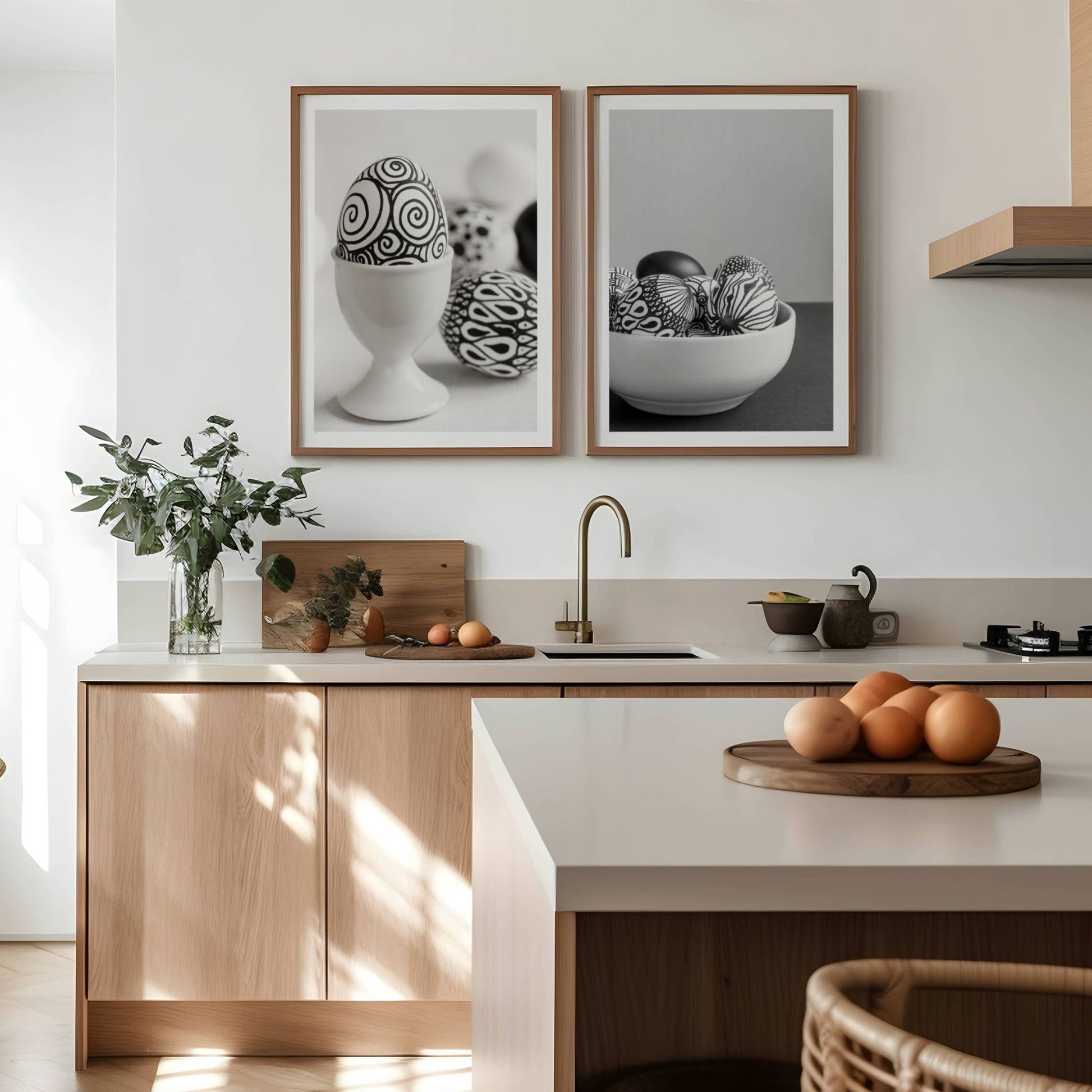 Med håndmalte, kunstneriske påskeegg som motiv, bringer dette settet en minimalistisk og moderne estetikk til enhver vegg. Illustrasjon viser plakatene med hvit kant i rammer av eik på et kjøkken.