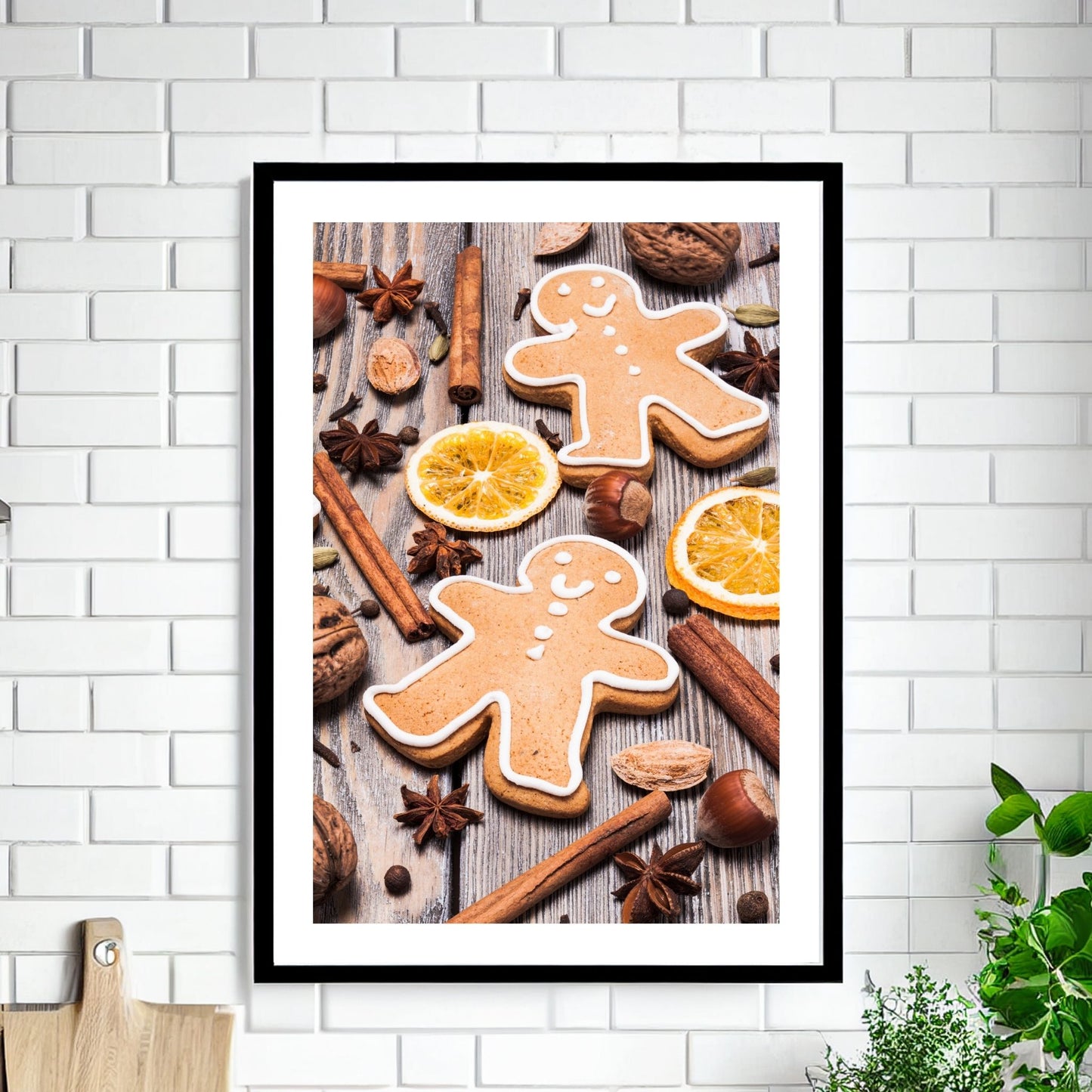 Plakat med dekorativt førjulsmotiv - pepperkaker, appelsin, kanel og stjerneanis, det som hører julen til. Illustrasjonen viser plakaten i sort ramme som henger på en vegg.