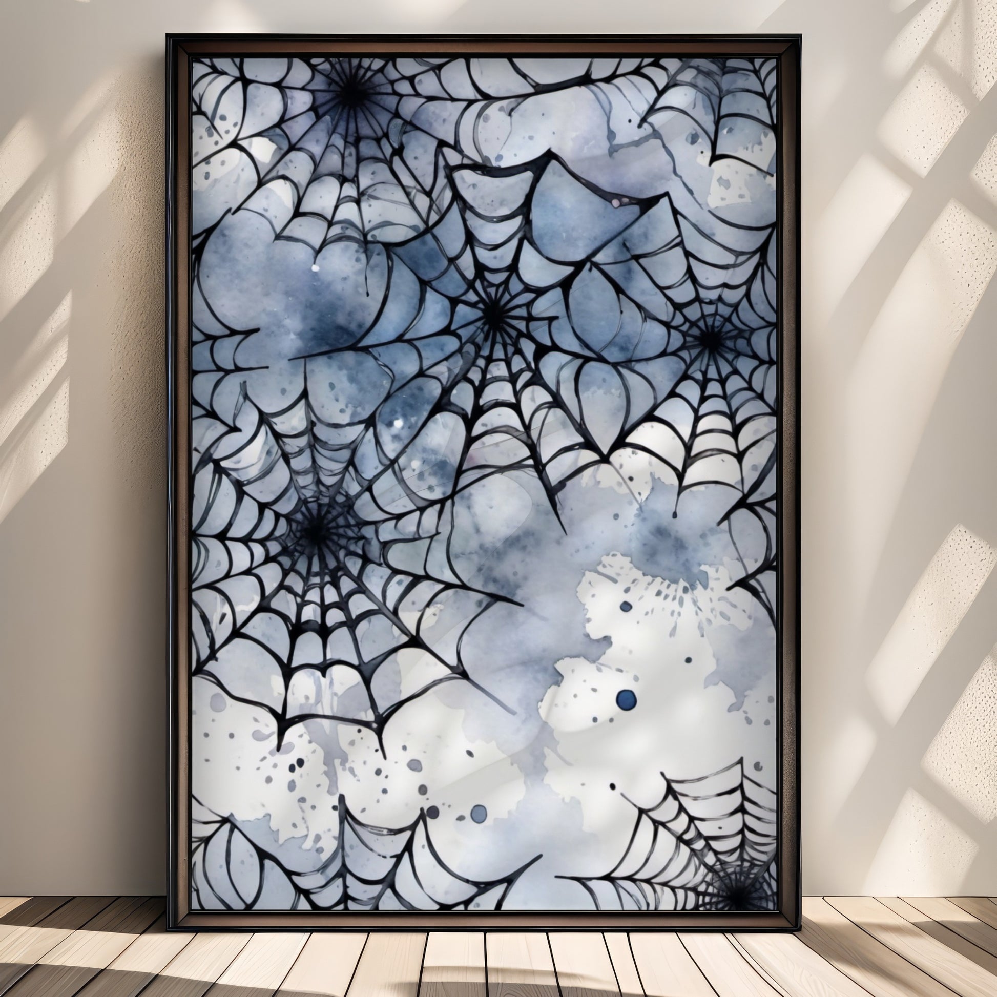 “Tangled Webs” er en kunstnerisk samling av flere edderkoppnett i sort blekk og blåtoner. Illustrasjon viser plakat uten hvit kant i sort ramme.