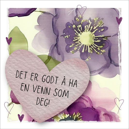 Go'ord plakat med et lilla hjerte med teksten "Det er godt å ha en venn som deg" på en bakgrunn med blomstermotiv i lilla, burgunder og grønt. Hvit kant på 1,5 cm. som fremhever og gir bildet dybde.