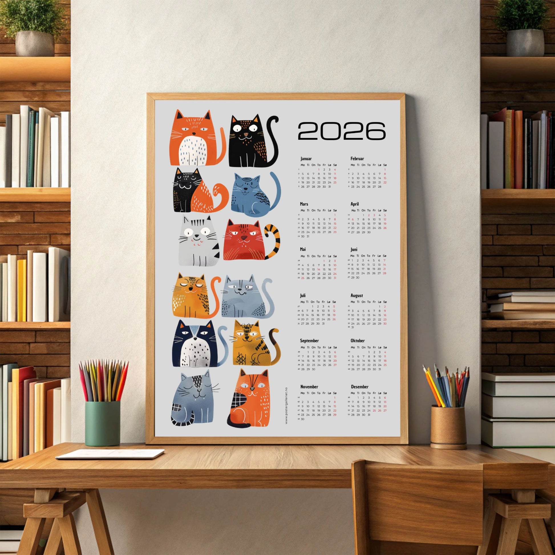 Grafisk kalender 2026 med fargerik katteillustrasjon og moderne layout. Illustrasjon viser kalender i eik ramme.