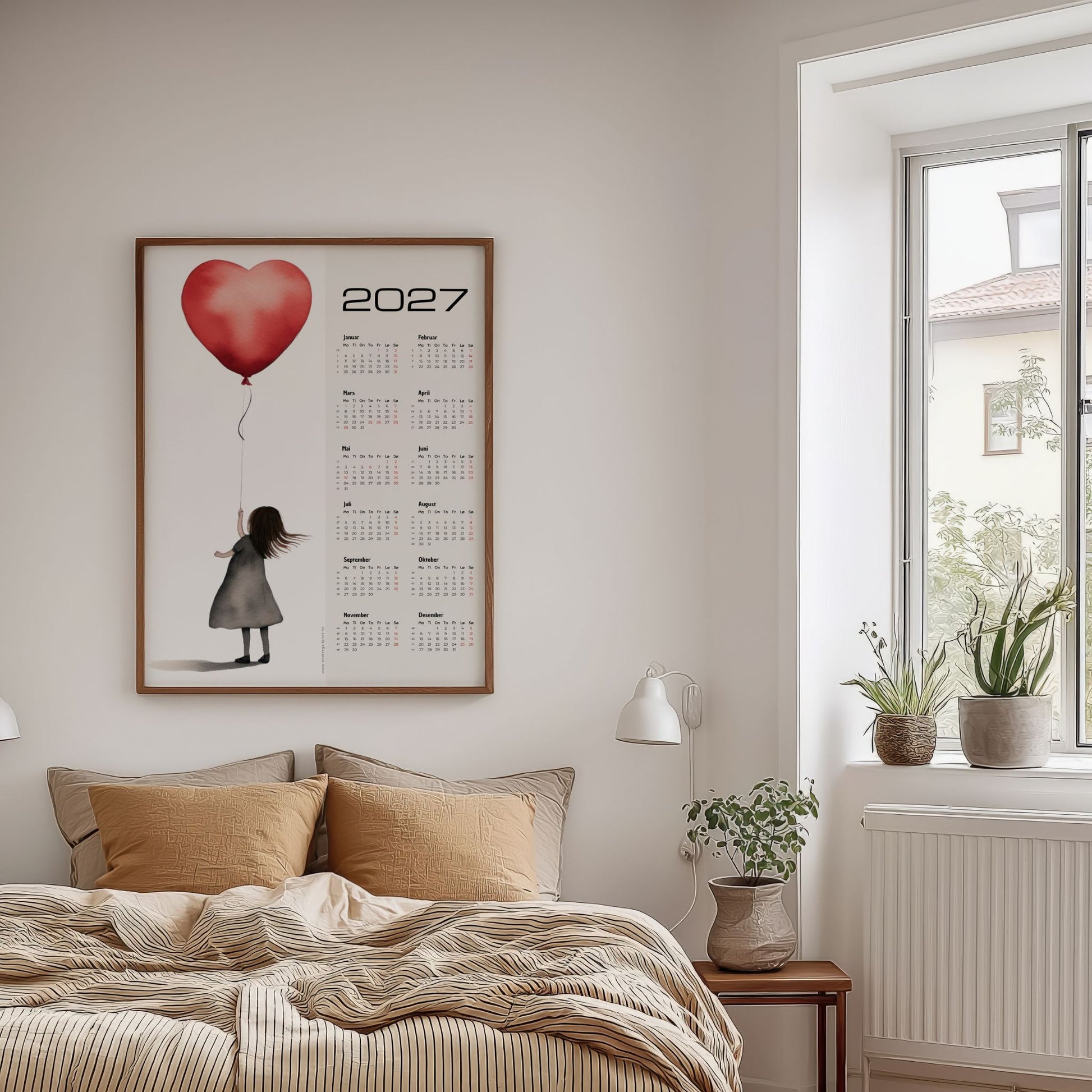Minimalistisk kalender 2027 med rød hjerteballong vist på veggen i lyst soverom.
