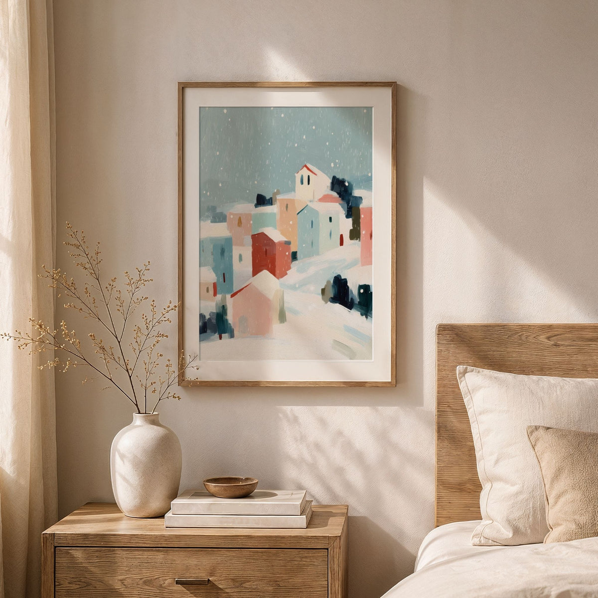 Snowfall Village vinterplakat med hvit passepartout i lyst soverom med naturmaterialer.