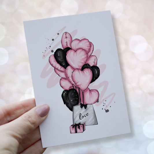 Illustrasjon av valentineskort med rosa og sorte hjerteballonger, gave og pose merket love, moderne og elegant uttrykk. Kortet holdes i en hånd.