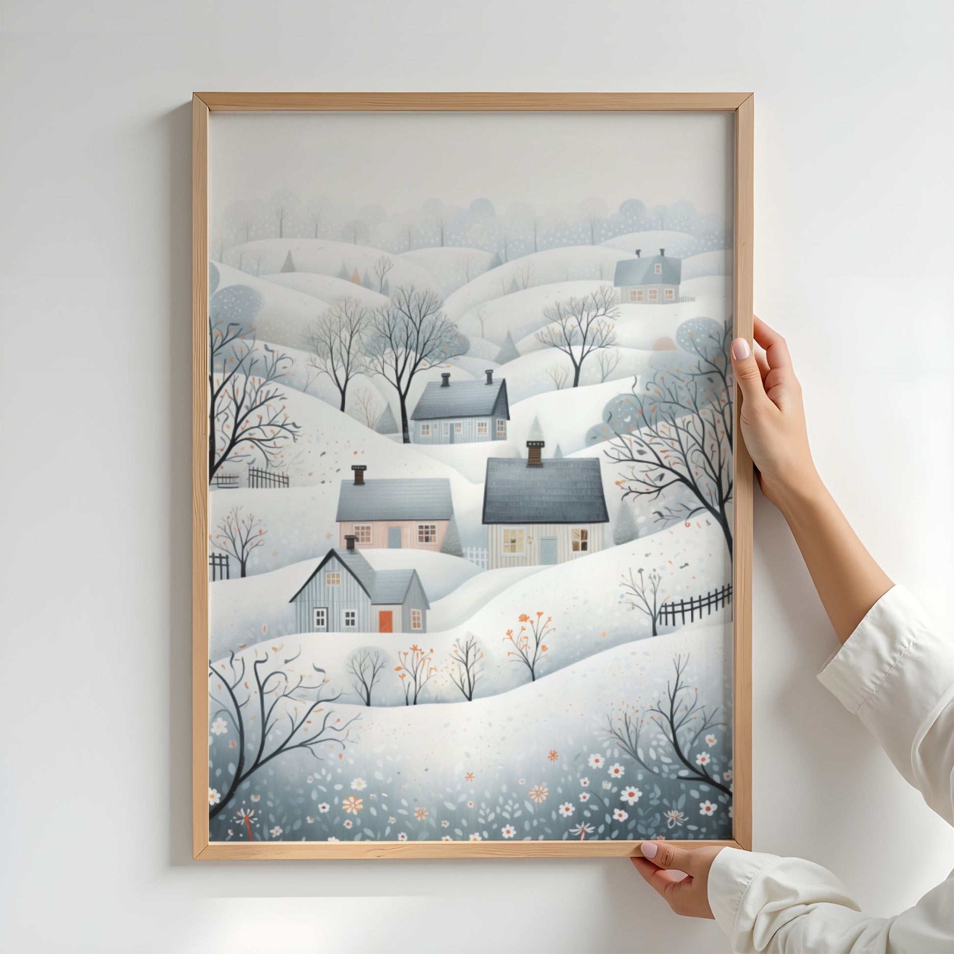 Vinterdalen plakat med snødekte åser, små hus og rolige nordiske vinterfarger. Illustrasjon viser plakat uten hvit kantlinje i eik ramme.