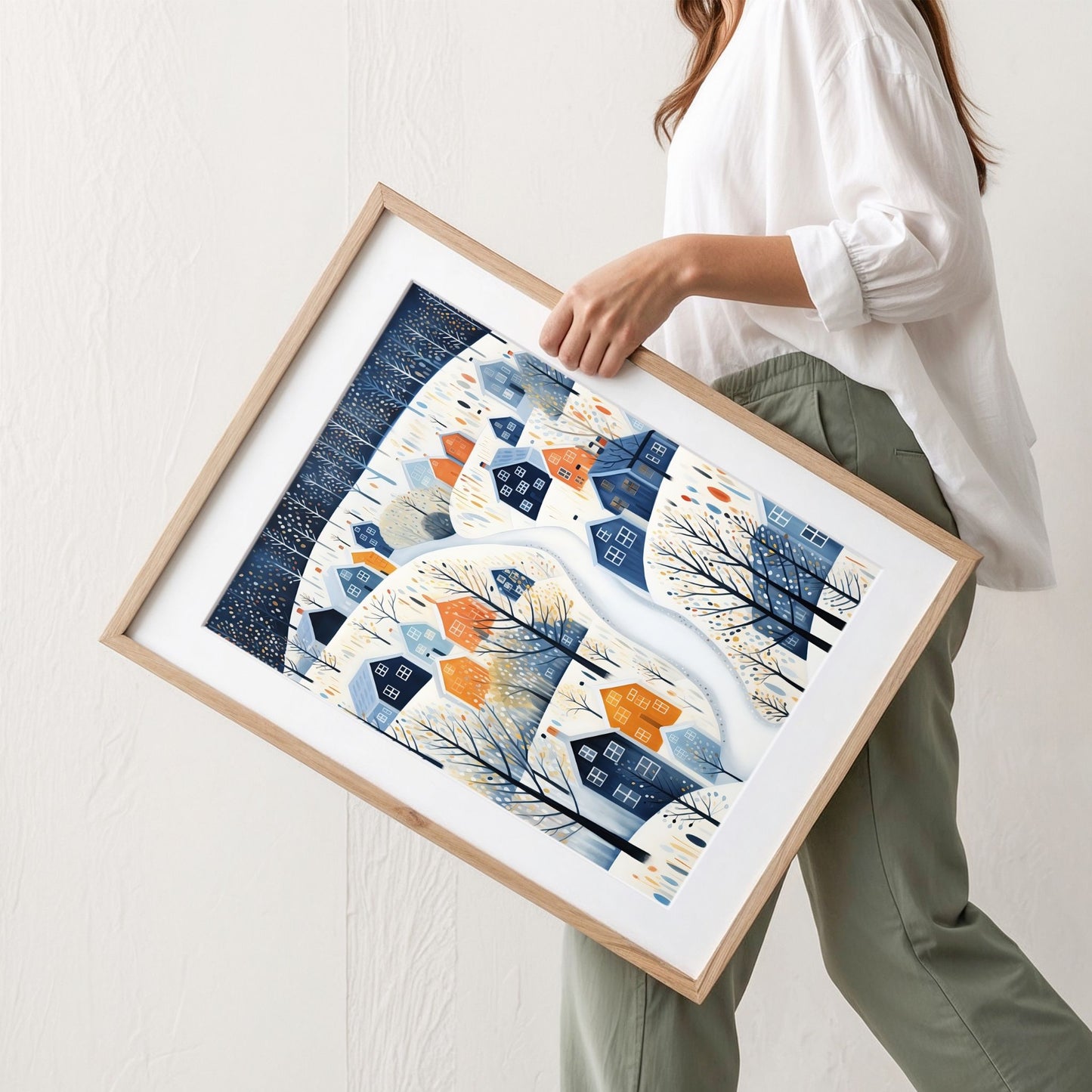 Vinterstien plakat med moderne vinterlandskap, blå og okergule hus og grafiske vintertrær. Illustrasjon viser plaktat med passepartout i eik ramme.